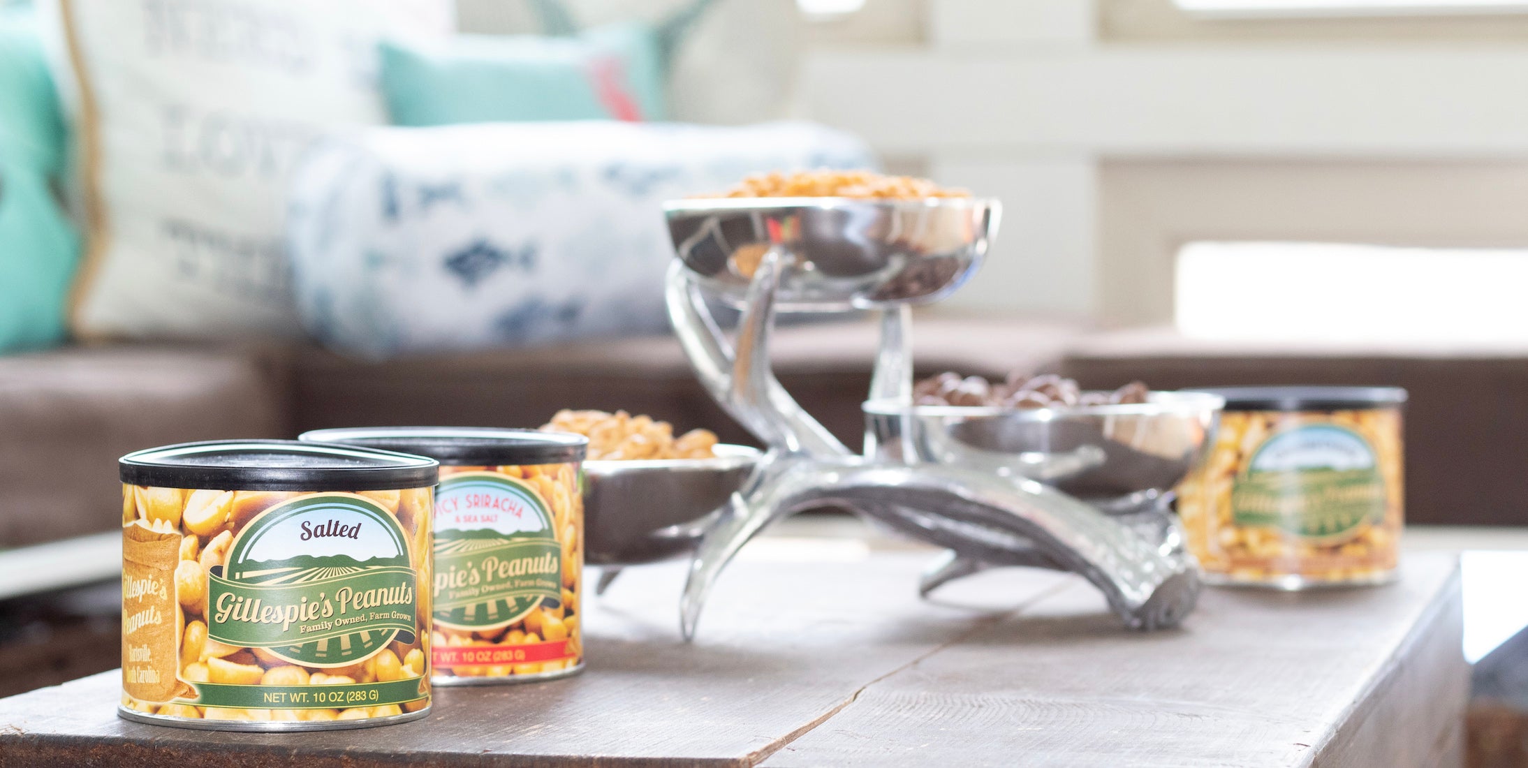 Cans of Gillespie's Salted and Honey Roasted peanuts on a porch table