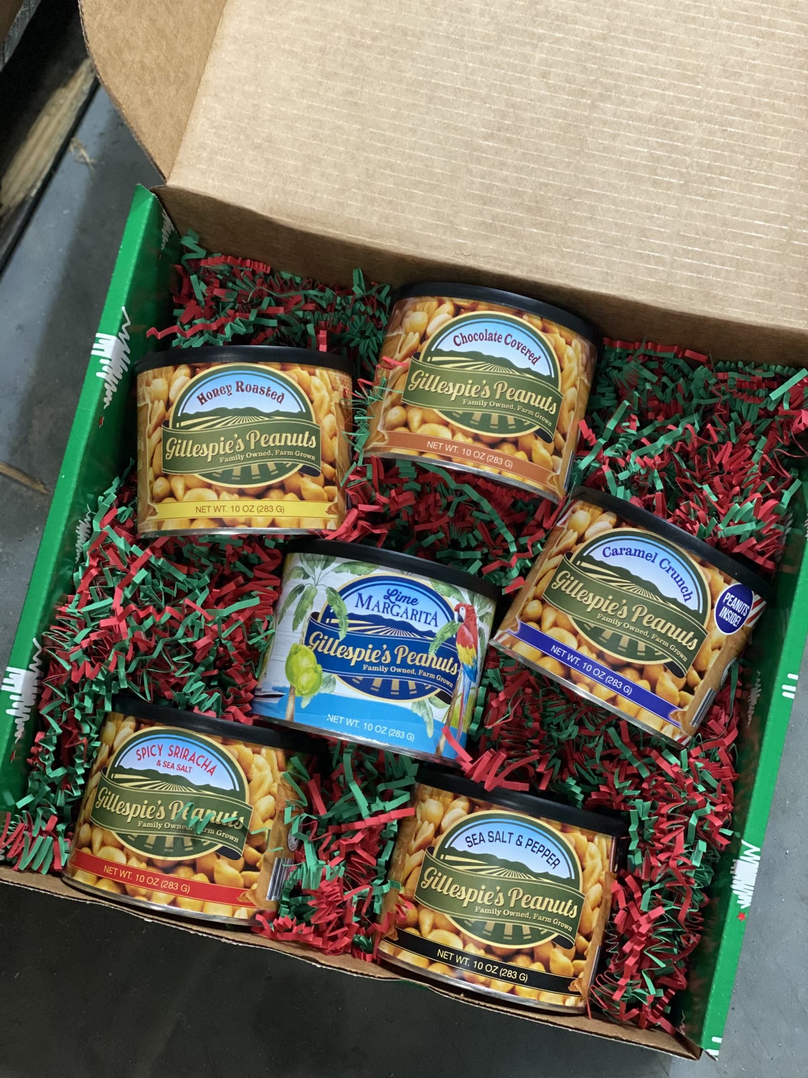 Six cans of Gillespie's Peanuts in a gift box