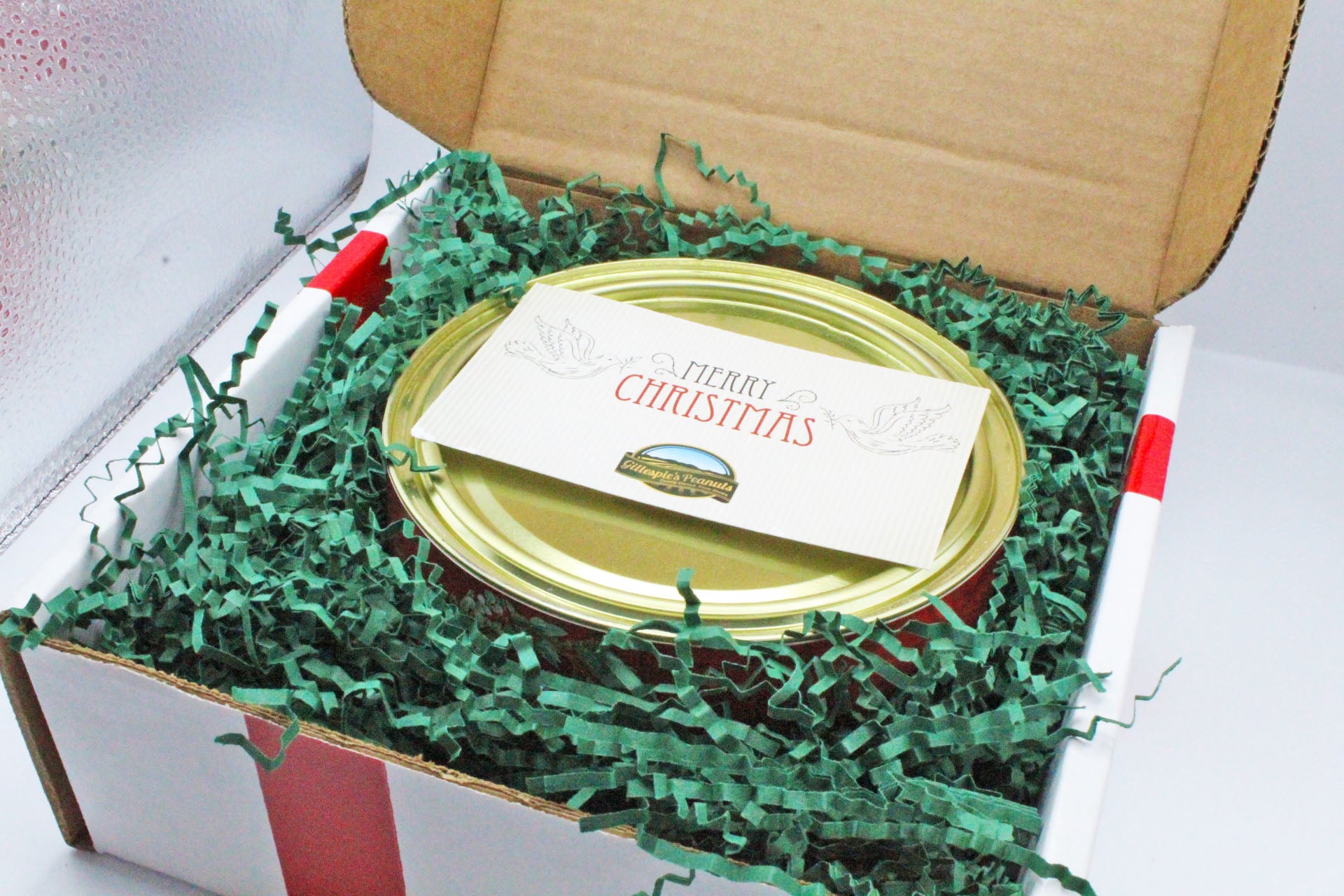 A Gillespie's can in a holiday gift box with a Merry Christmas card